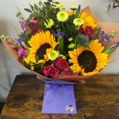 Bight Summer Sunflower - Florist choice of bright seasonal flowers including sunflowers in the design.
