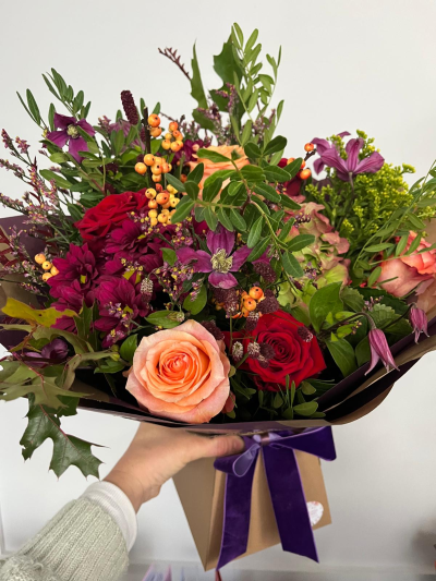 Autumn Berry - A luxurious hand-tied arrangement inspired by the rich colours and textures of an autumn garden. Deep crimson, soft peach and plum-toned blooms are beautifully complemented by seasonal foliage, decorative berries and delicate botanical accents, creating a bouquet full of depth, character and natural beauty. Presented in stylish wrapping and finished with a sumptuous ribbon, this sophisticated design is perfect for birthdays, anniversaries, thank-you gifts or any occasion that calls for something truly special and memorable.