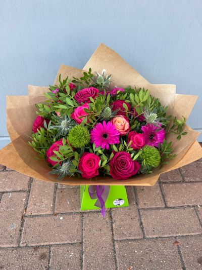 Hot pink pop - Bright vibrant bouquet made with a mix of hot pink germini and premium roses amongst lime green foliage and blooms to really make it pop.
