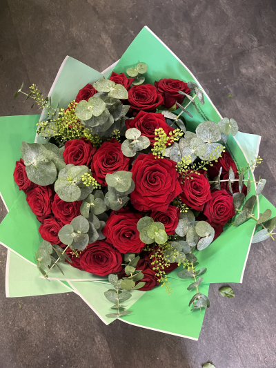 24 premium red roses - 24 premium red Naomi for that sweet scent with a mixture of foliage including predominantly eucalyptus to make the roses pop.