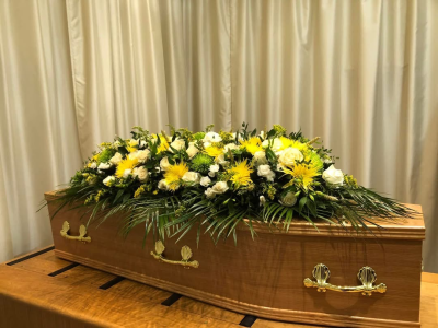 Fields of gold coffin spray - Chrysanthemums in green, yellow and white, dried corn and foliage.